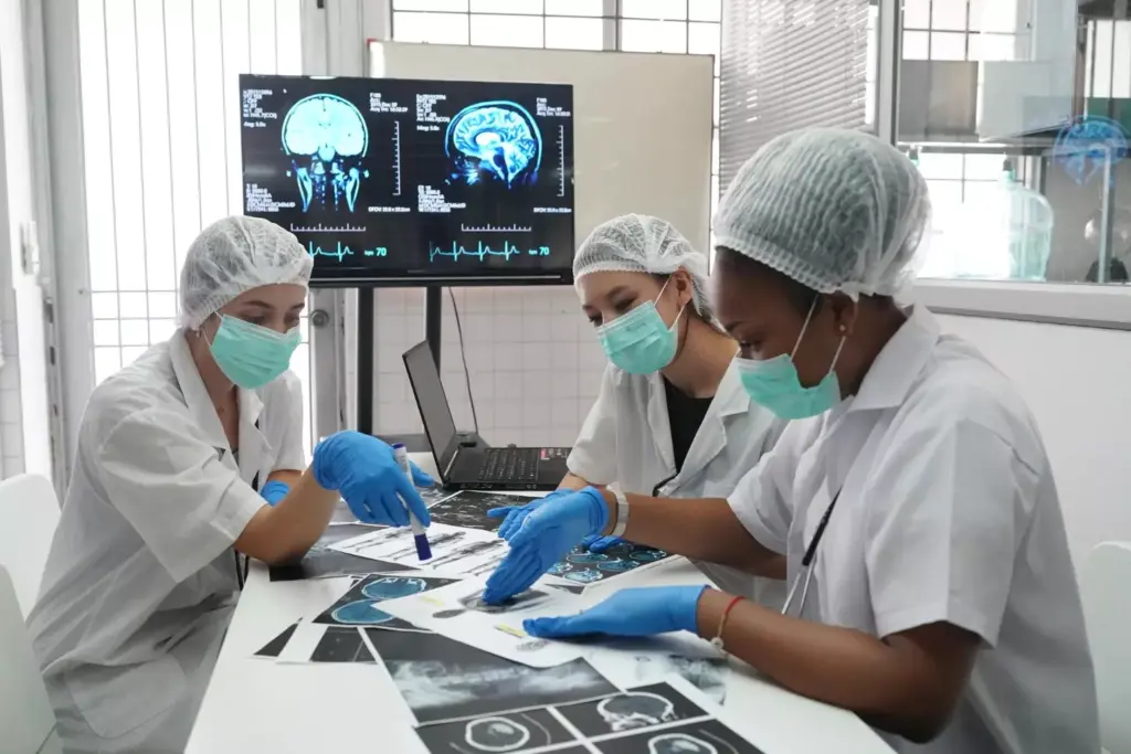 A highly detailed medical illustration depicting the brain biopsy procedure. The subject is positioned on an operating table, surrounded by a team of surgeons wearing sterile gowns and gloves. In the foreground, a surgeon is carefully inserting a thin needle into the patient's skull, guided by a high-resolution CT scan image displayed on a nearby monitor. The middle ground shows various surgical instruments and equipment, including a powerful microscope and a tray of specialized tools. The background is dimly lit, creating a somber, focused atmosphere in the operating room. The lighting is soft, directional, and casts long shadows, highlighting the delicate nature of the procedure. The scene conveys a sense of precision, expertise, and the gravity of the medical intervention. A highly detailed medical illustration depicting the brain biopsy procedure. The subject is positioned on an operating table, surrounded by a team of surgeons wearing sterile gowns and gloves. In the foreground, a surgeon is carefully inserting a thin needle into the patient's skull, guided by a high-resolution CT scan image displayed on a nearby monitor. The middle ground shows various surgical instruments and equipment, including a powerful microscope and a tray of specialized tools. The background is dimly lit, creating a somber, focused atmosphere in the operating room. The lighting is soft, directional, and casts long shadows, highlighting the delicate nature of the procedure. The scene conveys a sense of precision, expertise, and the gravity of the medical intervention.