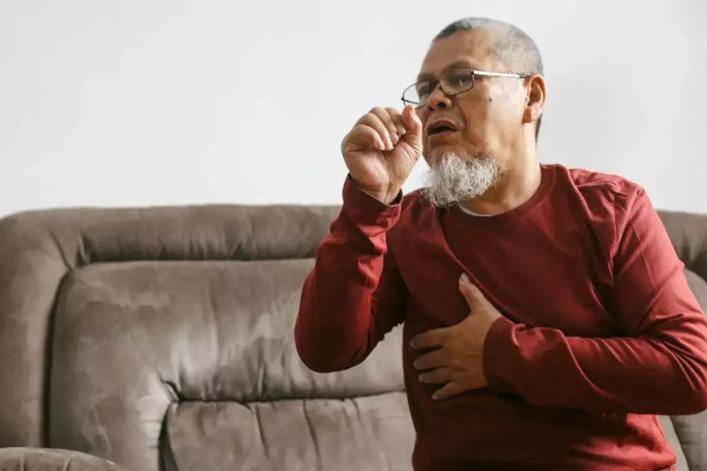 A close-up view of a person's throat, with a focus on the vocal cords and surrounding tissues. The image should clearly depict the characteristic cough associated with atrial fibrillation (AFib), showcasing the raspy, hoarse, and intermittent nature of the cough. The subject's face should be partially visible, with a slight frown or pained expression, conveying the discomfort and irritation caused by the AFib cough. The lighting should be soft and natural, creating a sense of clinical observation, while the depth of field should emphasize the central area of interest. The background should be neutral and uncluttered, allowing the viewer to concentrate on the defining features of the AFib cough. A close-up view of a person's throat, with a focus on the vocal cords and surrounding tissues. The image should clearly depict the characteristic cough associated with atrial fibrillation (AFib), showcasing the raspy, hoarse, and intermittent nature of the cough. The subject's face should be partially visible, with a slight frown or pained expression, conveying the discomfort and irritation caused by the AFib cough. The lighting should be soft and natural, creating a sense of clinical observation, while the depth of field should emphasize the central area of interest. The background should be neutral and uncluttered, allowing the viewer to concentrate on the defining features of the AFib cough.