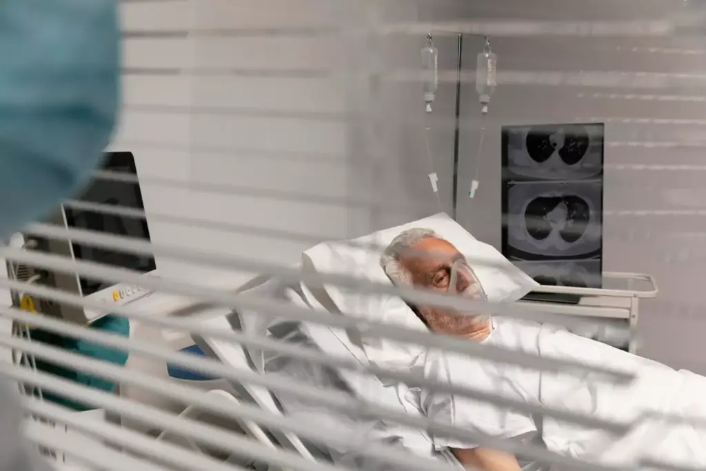 A dimly lit hospital room, the air heavy with the scent of medical equipment and the somber weight of impending loss. In the foreground, a frail figure lies motionless on a crisp white sheet, their features sunken and pale, eyes closed in a restless slumber. Surrounding them, a halo of medical devices, tubes, and monitors, each blinking and whirring with a sense of urgency. The background is shrouded in a muted, monochromatic palette, emphasizing the isolation and the gravity of the situation. Soft, directional lighting casts long shadows, highlighting the stark contrast between life and the looming specter of death. The scene conveys a sense of profound sorrow, a quiet contemplation of the inevitable, and the poignant realization of the fragility of human existence.