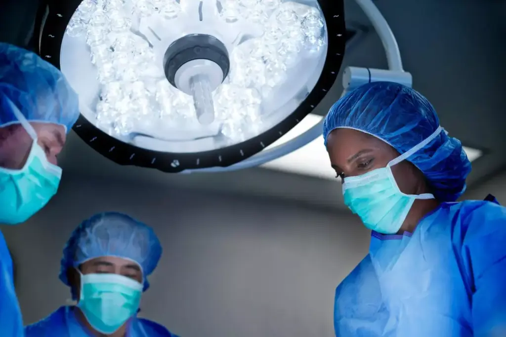 A detailed surgical scene showcasing the intricate process of brain neoplasm removal. In the foreground, skilled neurosurgeons meticulously operate using advanced instruments under a brilliant surgical lamp, their movements precise and concentrated. The middle ground reveals the patient's exposed brain, the tumor clearly visible amidst the delicate neural tissue. The background blurs into a sterile, high-tech operating room, with monitors displaying real-time data and diagnostic imagery. Crisp, clinical lighting casts long shadows, conveying the gravity and importance of the procedure. An atmosphere of intense focus and determination permeates the scene, reflecting the critical nature of this foundation of brain cancer treatment.