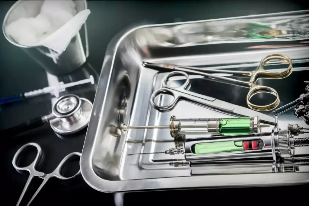 A dimly lit operating room, with various surgical instruments and tools laid out on a stainless steel tray. In the foreground, a scalpel, forceps, and sutures are neatly arranged, casting long shadows on the surface. In the middle ground, a complex array of surgical implements, including clamps, retractors, and specialized probes, are positioned with precision. The background is a blur of activity, with medical staff in sterile gowns and masks moving with focused intent, surrounded by advanced medical equipment and bright surgical lights. The scene conveys a sense of technical expertise, meticulous preparation, and the gravity of the procedures performed within this specialized environment.