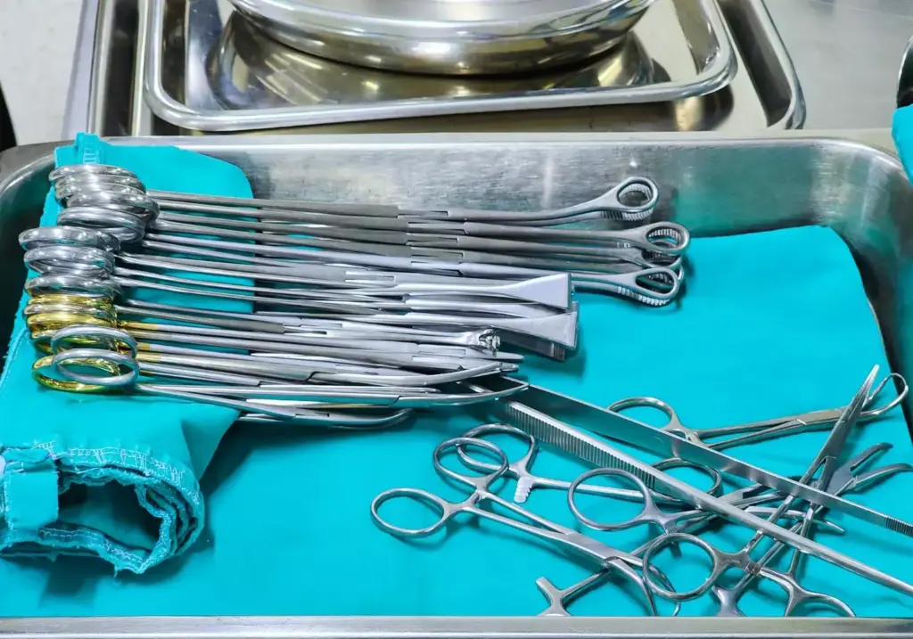 A well-lit, high-resolution image of a surgical tray displaying an assortment of traditional laparoscopic equipment, including a laparoscope with a high-definition camera, grasping forceps, scissors, electrocautery tools, and other specialized instruments. The tools are arranged neatly and precisely, with a sense of order and professionalism. The background is a clean, sterile medical environment, with subtle textures and neutral tones that allow the equipment to take center stage. The overall scene conveys the technical precision and expertise required for a successful laparoscopic procedure.