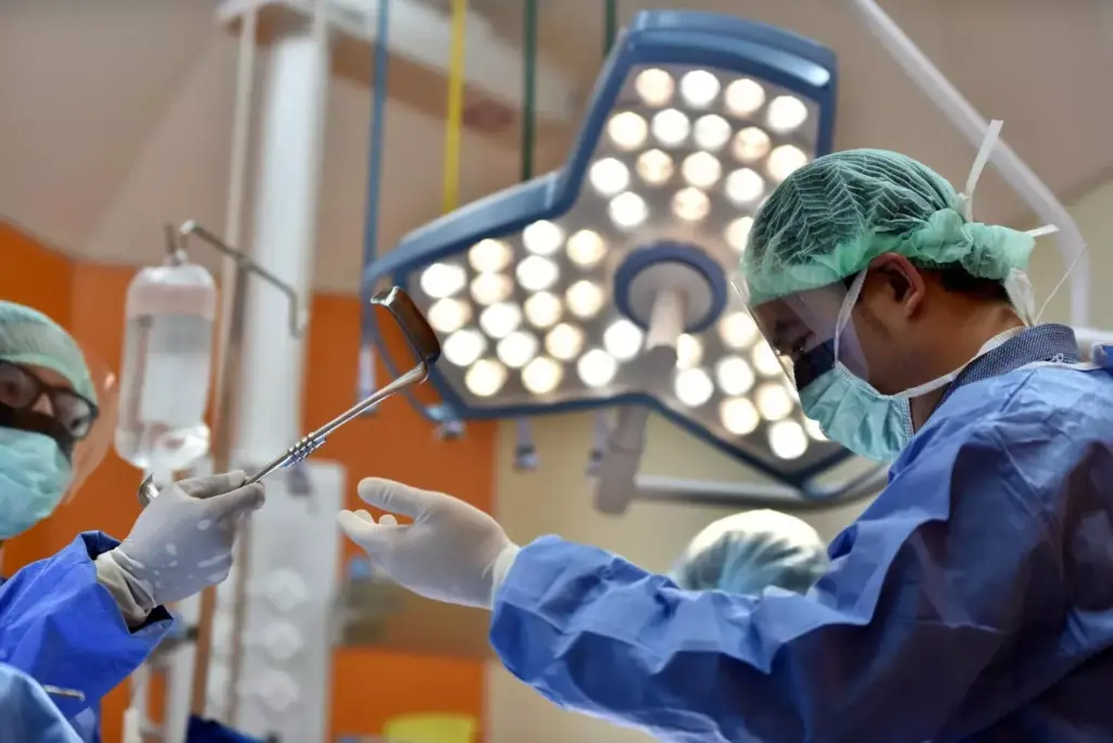 A minimally invasive laparoscopic surgical procedure taking place in a modern operating theater. The scene depicts the surgeon's hands maneuvering surgical instruments through small incisions in the patient's abdomen, with a high-definition display providing a detailed view of the internal anatomy. Bright overhead lighting illuminates the sterile surgical field, while the background shows the hospital's advanced medical equipment and staff assisting the surgeon. The atmosphere conveys a sense of precision, expertise, and patient care. A minimally invasive laparoscopic surgical procedure taking place in a modern operating theater. The scene depicts the surgeon's hands maneuvering surgical instruments through small incisions in the patient's abdomen, with a high-definition display providing a detailed view of the internal anatomy. Bright overhead lighting illuminates the sterile surgical field, while the background shows the hospital's advanced medical equipment and staff assisting the surgeon. The atmosphere conveys a sense of precision, expertise, and patient care.