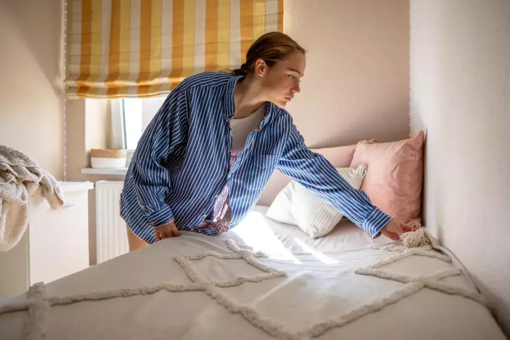 A comfortable yet stylish man's outfit after prostate surgery, featuring soft, breathable fabrics that provide support and ease of movement. In the foreground, a pair of loose-fitting, drawstring waist pants in a neutral, soothing color like heather gray. The middle ground showcases a button-down shirt in a subtly textured, natural material like organic cotton, with a relaxed, open collar. The background shows a plush, oversized cardigan or robe in a cozy, muted tone, providing additional warmth and comfort. The lighting is soft and diffused, creating a calming, therapeutic atmosphere. The camera angle is slightly elevated, capturing the ensemble from a slightly above perspective, conveying a sense of ease and care.