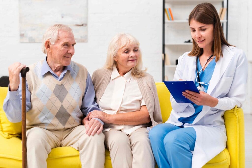 A group of patients in their 60s-70s, seated comfortably in a well-lit medical clinic.