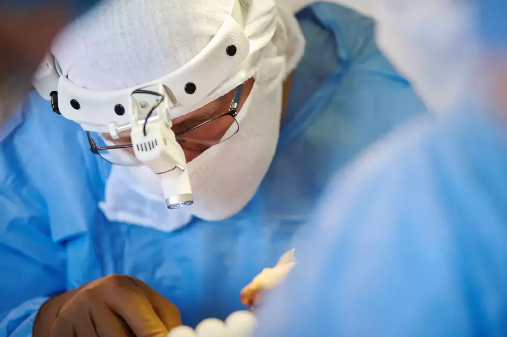 A detailed surgical view of a cervical fusion procedure. In the foreground, a skilled surgeon's hands manipulate specialized medical instruments, delicately repositioning vertebrae. The middle ground reveals the intricate anatomy of the cervical spine, with bones, discs, and nerves illuminated under bright surgical lights. The background showcases a modern operating room, with gleaming medical equipment and a serene, clinical atmosphere. The scene conveys the precision, expertise, and care required to perform this complex spinal surgery, which aims to alleviate neck pain and restore mobility.