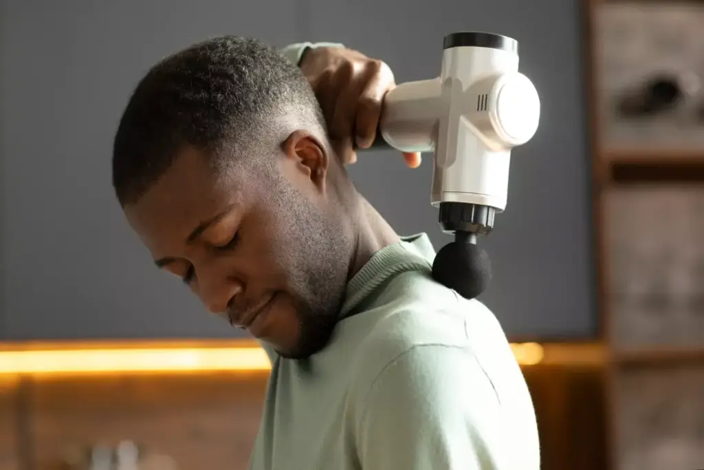 Neck and shoulder tension relief: A serene scene of a person in a peaceful state, their head tilted back with eyes closed, shoulders relaxed and muscles visibly unwound. Warm, soft lighting illuminates the figure, creating a calming atmosphere. The background is blurred, allowing the focus to remain on the subject's upper body, highlighting the release of tension and stress. The composition emphasizes the transition from strain to tranquility, conveying a sense of restorative calm and rejuvenation.