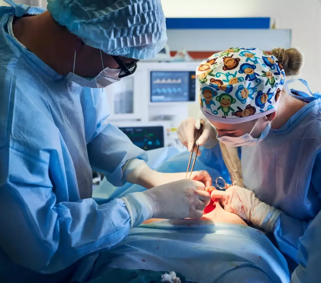 A detailed surgical scene depicting a double knee replacement operation in progress. In the foreground, the surgeon's gloved hands meticulously manipulate surgical instruments, expertly exposing and reshaping the knee joints. In the middle ground, a clear view of the open surgical site reveals the precise incisions and implants being carefully installed. The background showcases the sterile, well-lit operating theater, with medical staff attentively monitoring the procedure. The lighting is bright and clinical, casting a sense of focused intensity. The overall mood conveys the gravity and technical precision of this delicate orthopedic surgery.