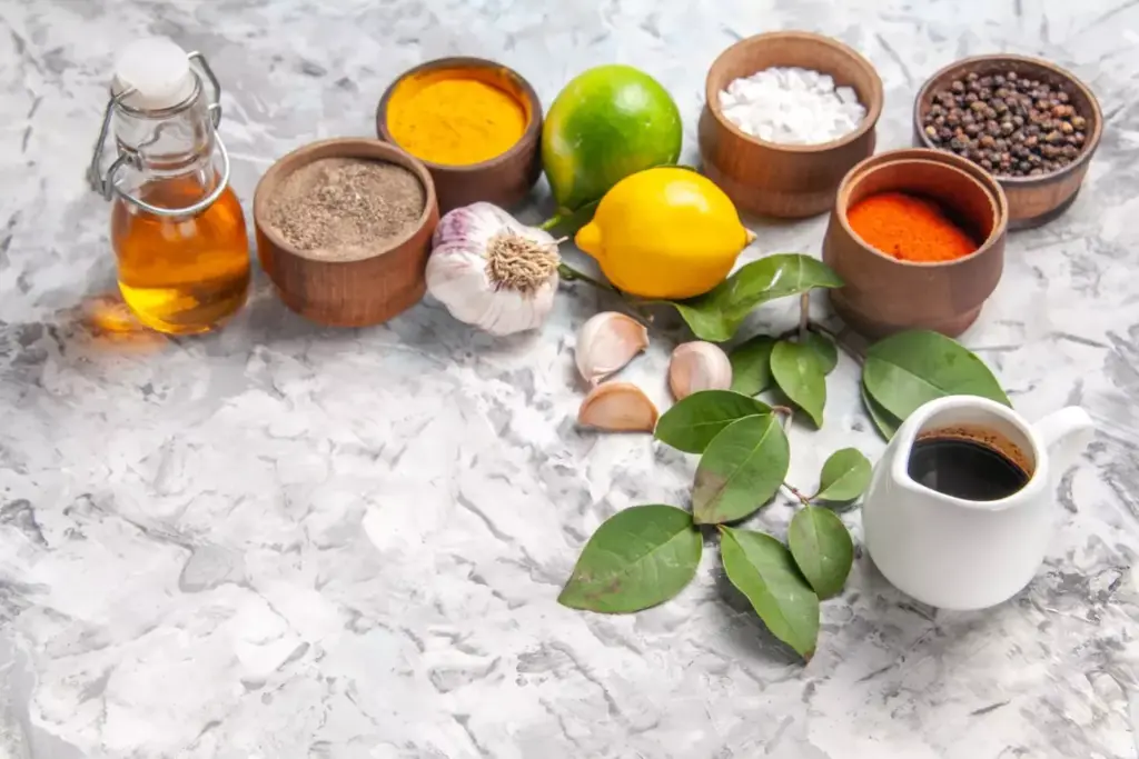 A serene botanical illustration depicting a variety of natural remedies for joint inflammation. In the foreground, a collection of fresh herbs and spices such as ginger, turmeric, cayenne pepper, and rosemary are arranged artfully. In the middle ground, a mortar and pestle grinds these ingredients into a paste, hinting at the preparation of a soothing topical treatment. The background features a lush, verdant landscape with rolling hills and a clear blue sky, conveying a sense of nature's restorative power. The lighting is soft and diffused, creating a calming, naturalistic atmosphere. The perspective is slightly elevated, allowing the viewer to appreciate the harmonious composition of natural elements.