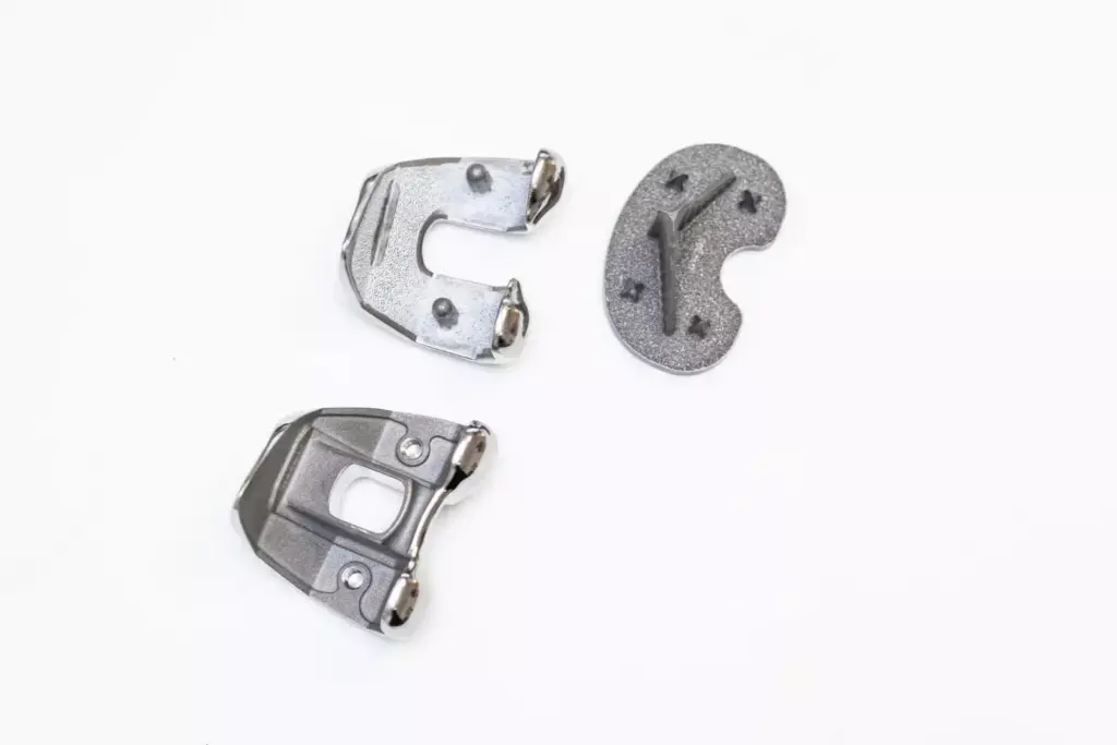 A sleek, high-tech display showcasing a variety of custom knee replacement implant models, each with distinct design features and branding. The foreground features a clean, minimalist arrangement of the implants, with carefully lit and angled shots to highlight their material compositions, joint mechanisms, and sculpted contours. The middle ground includes technical diagrams and schematics providing insights into the engineering and biomechanics of the devices. The background is a softly blurred, laboratory-like environment, conveying a sense of clinical precision and innovation. The overall mood is one of precision, sophistication, and the advancement of orthopedic medical technology. A sleek, high-tech display showcasing a variety of custom knee replacement implant models, each with distinct design features and branding. The foreground features a clean, minimalist arrangement of the implants, with carefully lit and angled shots to highlight their material compositions, joint mechanisms, and sculpted contours. The middle ground includes technical diagrams and schematics providing insights into the engineering and biomechanics of the devices. The background is a softly blurred, laboratory-like environment, conveying a sense of clinical precision and innovation. The overall mood is one of precision, sophistication, and the advancement of orthopedic medical technology.