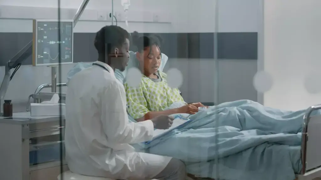 A dimly lit hospital room, a patient reclining comfortably in a chair as a nurse carefully administers a chemotherapy infusion. The patient's expression is one of resolve, their face illuminated by the soft glow of the IV drip. The scene is captured in a cinematic, slightly low-angle perspective, emphasizing the gravity and significance of the moment. The background is blurred, drawing the viewer's focus to the central subject and the intricate medical equipment. The lighting is warm and muted, creating a sense of intimacy and empathy. The overall mood is somber yet hopeful, reflecting the patient's journey through cancer treatment.
