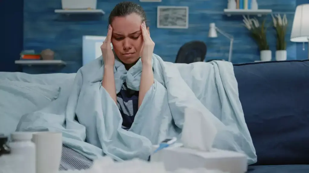 A person experiencing chemo headache symptoms, depicted with a pained expression, clutching their head. The foreground shows the person's face in close-up, highlighting the furrowed brow, squinted eyes, and grimace. The middle ground blurs into a hazy, muted background, conveying a sense of discomfort and distress. Soft, warm lighting illuminates the subject, casting subtle shadows to accentuate the facial features. The overall mood is one of discomfort and suffering, capturing the essence of the "Chemo Headache: Types, Symptoms, and Patterns" section. A person experiencing chemo headache symptoms, depicted with a pained expression, clutching their head. The foreground shows the person's face in close-up, highlighting the furrowed brow, squinted eyes, and grimace. The middle ground blurs into a hazy, muted background, conveying a sense of discomfort and distress. Soft, warm lighting illuminates the subject, casting subtle shadows to accentuate the facial features. The overall mood is one of discomfort and suffering, capturing the essence of the "Chemo Headache: Types, Symptoms, and Patterns" section.