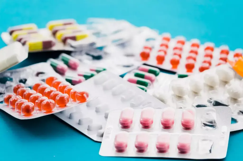 A vibrant, detailed illustration of chemotherapy drugs used for the treatment of lymphoma. In the foreground, a collection of pharmaceutical vials and syringes, their labels prominently displaying the names of common chemotherapy agents like cyclophosphamide, doxorubicin, vincristine, and prednisone. The middle ground features a medical laboratory setting, with test tubes, beakers, and other scientific equipment, conveying the precision and expertise involved in administering these potent therapies. In the background, a softly blurred yet recognizable lymph node structure, representing the target of these powerful drugs. The lighting is clean and clinical, with a slight blue hue to evoke the sterile environment of a hospital or research facility. The overall mood is one of medical authority, scientific innovation, and the hope of effective lymphoma treatment.