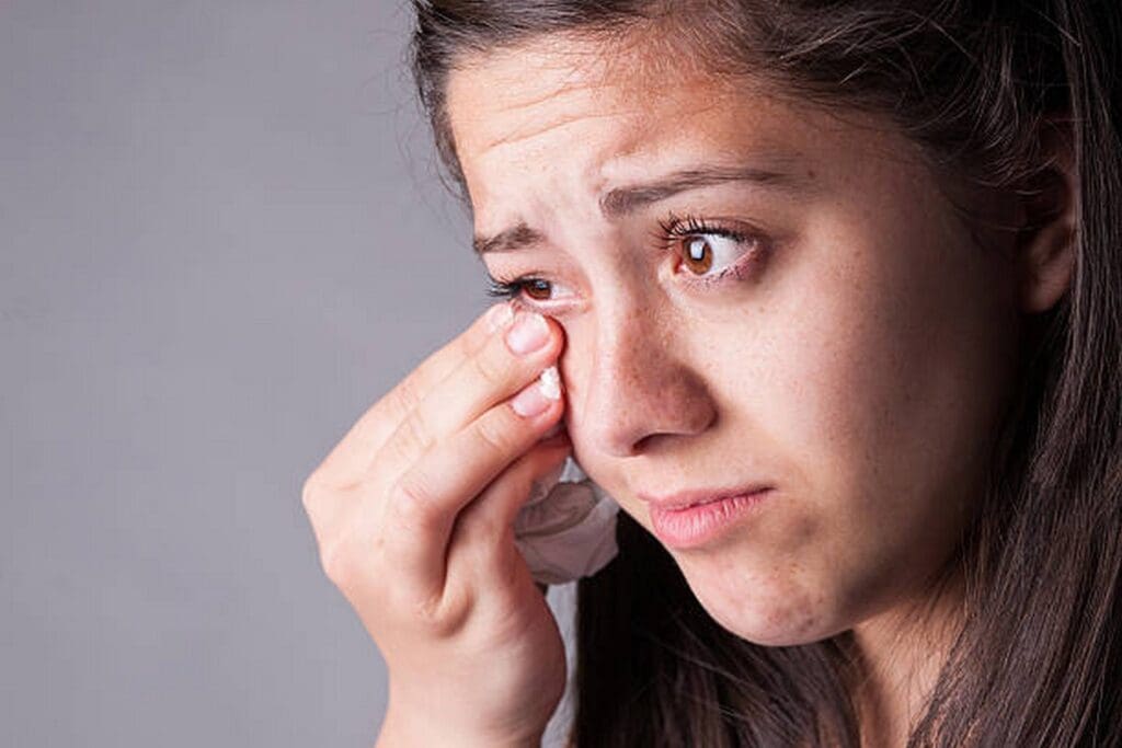 a patient with noticeable dark circles under her eyes
