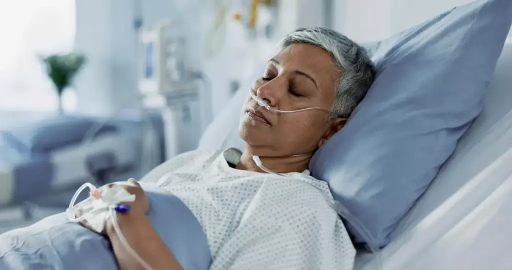 A well-lit, high-angle view of a hospital bed, with a chemotherapy infusion pump and IV line connected to a patient's arm. The patient's face is calm and serene, as a nurse carefully monitors the administration of the medication. The room is clean and sterile, with medical equipment and supplies neatly arranged. Soft, diffused lighting creates a soothing atmosphere, conveying the care and expertise of the healthcare professionals involved in the treatment process. The scene captures the essence of a lymphoma chemotherapy session, highlighting the necessary medical interventions while maintaining a sense of patient comfort and well-being.
