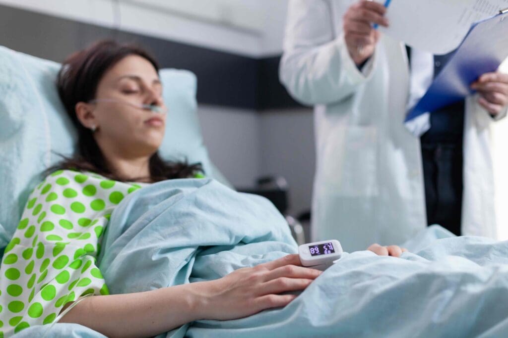 A serene and softly-lit clinical setting, with a woman resting comfortably in a hospital bed as she undergoes chemotherapy treatment for breast cancer