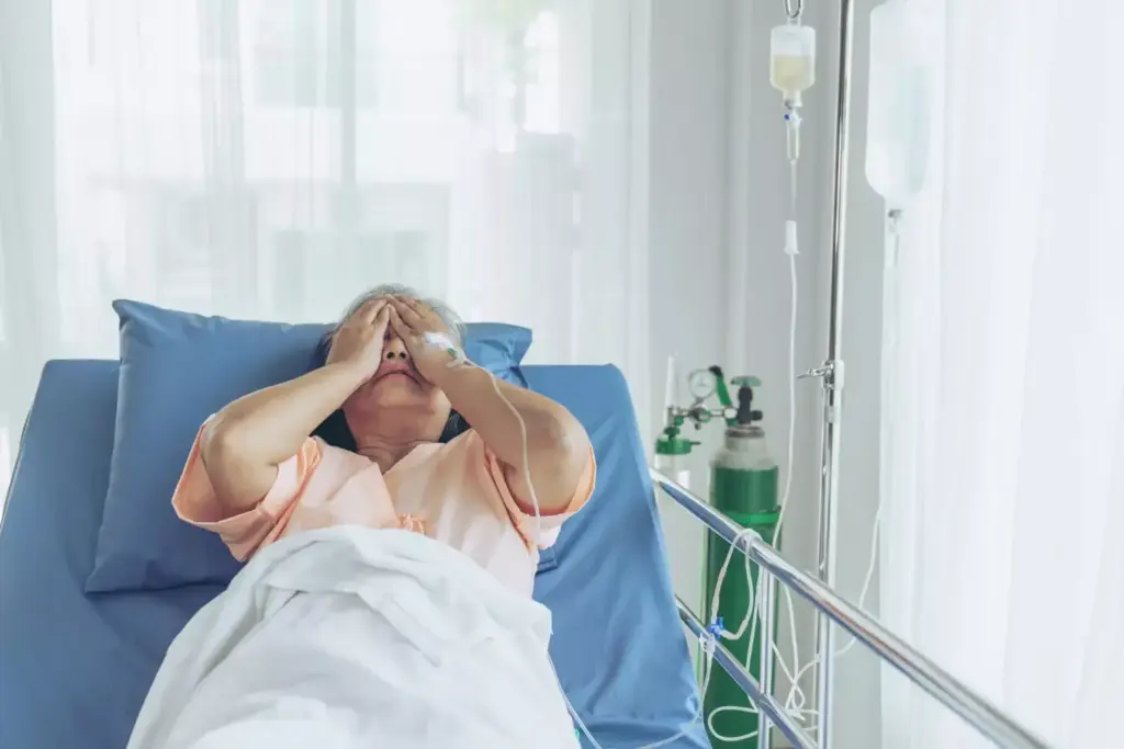 A person lying on a hospital bed, appearing exhausted and drained, with IV drips and medical equipment surrounding them. The background is a dimly lit hospital room, conveying a sense of weariness and the toll of chemotherapy treatment. Soft, diffuse lighting casts a somber, muted tone, emphasizing the patient's lack of energy. The composition focuses on the patient's face, displaying a pained expression and a faint, weary gaze, capturing the profound impact of chemotherapy on their energy levels. A person lying on a hospital bed, appearing exhausted and drained, with IV drips and medical equipment surrounding them. The background is a dimly lit hospital room, conveying a sense of weariness and the toll of chemotherapy treatment. Soft, diffuse lighting casts a somber, muted tone, emphasizing the patient's lack of energy. The composition focuses on the patient's face, displaying a pained expression and a faint, weary gaze, capturing the profound impact of chemotherapy on their energy levels.