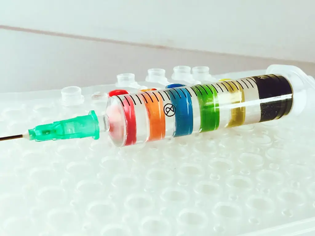 A detailed close-up view of a syringe filled with chemotherapy medication, resting atop an array of medical equipment and supplies. The syringe is centered in the frame, capturing the translucent amber liquid and the intricate needle. The background is a softly blurred hospital environment, with the faint outlines of IV stands, tubing, and other treatment paraphernalia. The lighting is clinical and precise, casting a cool, sterile ambiance. The composition emphasizes the significance and gravity of the TC chemotherapy regimen for breast cancer patients, conveying a sense of the care and precision required in its administration. A detailed close-up view of a syringe filled with chemotherapy medication, resting atop an array of medical equipment and supplies. The syringe is centered in the frame, capturing the translucent amber liquid and the intricate needle. The background is a softly blurred hospital environment, with the faint outlines of IV stands, tubing, and other treatment paraphernalia. The lighting is clinical and precise, casting a cool, sterile ambiance. The composition emphasizes the significance and gravity of the TC chemotherapy regimen for breast cancer patients, conveying a sense of the care and precision required in its administration.
