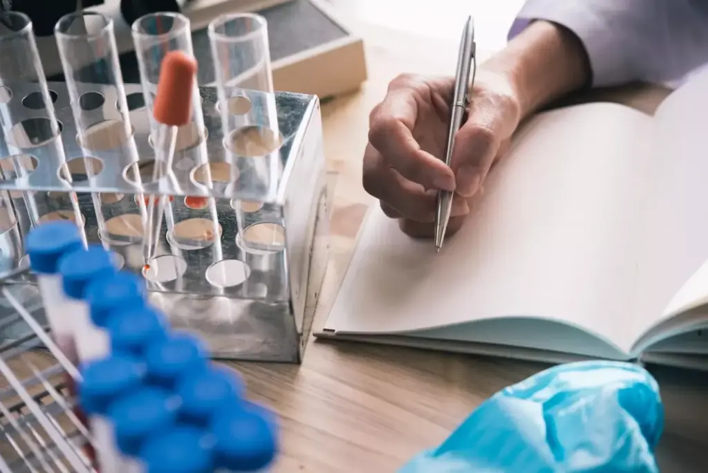A meticulously-detailed journal cover, featuring a closeup of medical research documents, laboratory glassware, and scientific instruments. The foreground showcases an open notebook with handwritten notes, a pen, and a petri dish. The middle ground displays a stethoscope, a microscope, and vials filled with liquid samples. The background is a softly-lit, clinical environment with a subtle grid pattern suggestive of data visualization. Warm lighting casts a contemplative, scholarly ambiance, highlighting the serious yet innovative nature of breast cancer research and treatment. The overall composition conveys the intellectual rigor and medical significance of the journal's content.