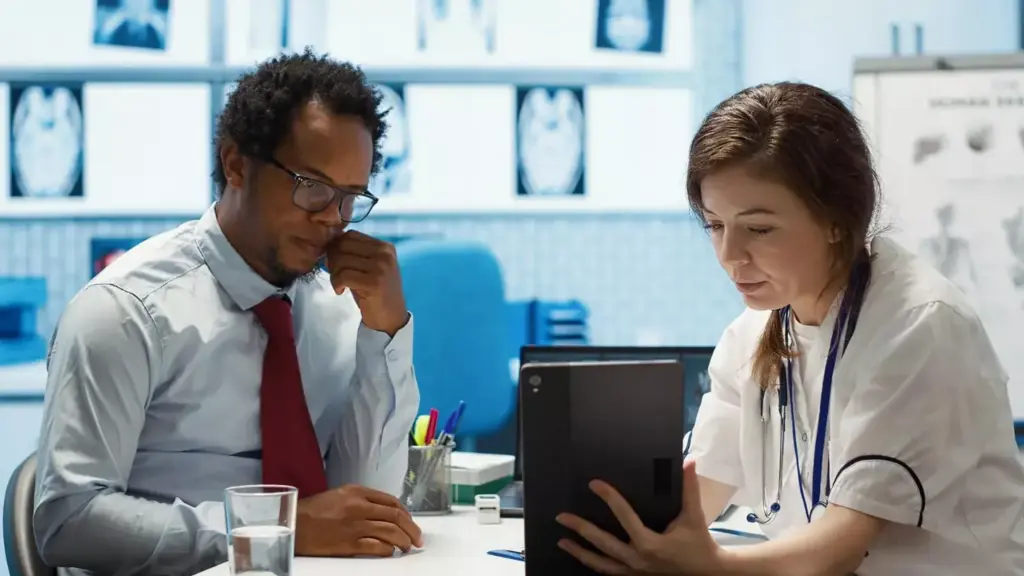 doctor presenting the test findings via scan interpretation on tablet doctor presenting the test findings via scan interpretation on tablet