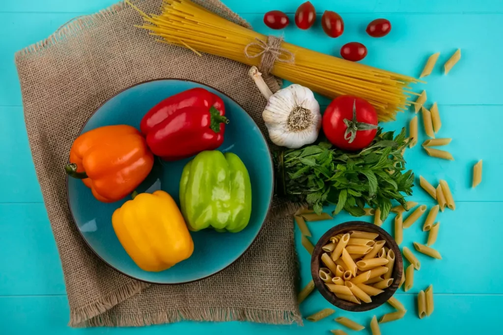 A vibrant still life showcasing a selection of nutrient-rich foods associated with colon cancer prevention and management. In the foreground, a variety of fresh, colorful produce including broccoli, kale, bell peppers, and tomatoes are artfully arranged against a wooden backdrop. Scattered throughout the scene are whole grains such as quinoa and brown rice, as well as nuts and seeds like walnuts and flaxseeds. The lighting is warm and natural, casting a soft glow across the scene and highlighting the vivid hues of the ingredients. The overall composition conveys a sense of balance, health, and a commitment to nourishing the body through wholesome, cancer-fighting foods. A vibrant still life showcasing a selection of nutrient-rich foods associated with colon cancer prevention and management. In the foreground, a variety of fresh, colorful produce including broccoli, kale, bell peppers, and tomatoes are artfully arranged against a wooden backdrop. Scattered throughout the scene are whole grains such as quinoa and brown rice, as well as nuts and seeds like walnuts and flaxseeds. The lighting is warm and natural, casting a soft glow across the scene and highlighting the vivid hues of the ingredients. The overall composition conveys a sense of balance, health, and a commitment to nourishing the body through wholesome, cancer-fighting foods.