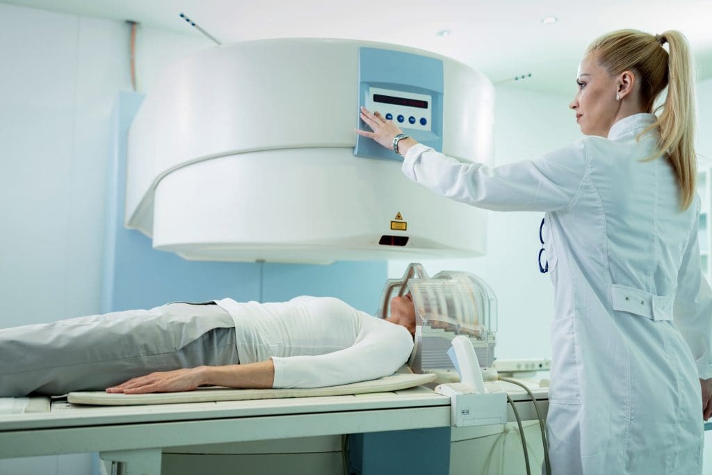 radiologist adjusting mri scanner before medical examination patient who is getting brain scan hospital LIV Hospital