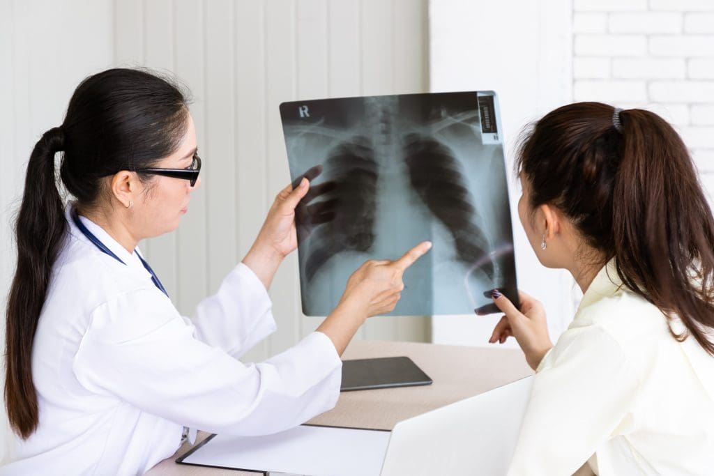 medical doctor give consultation patient with xray film LIV Hospital