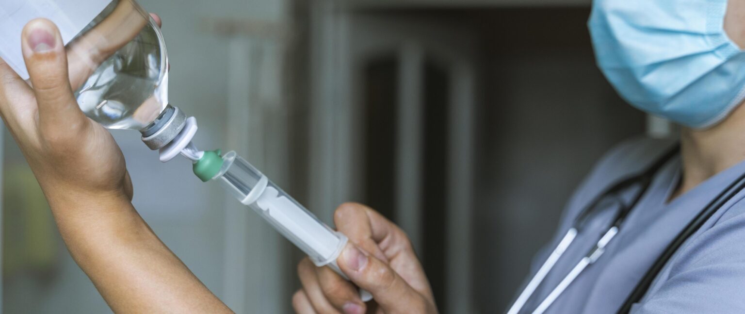 side view doctor filling up syringe with medicine 1 LIV Hospital