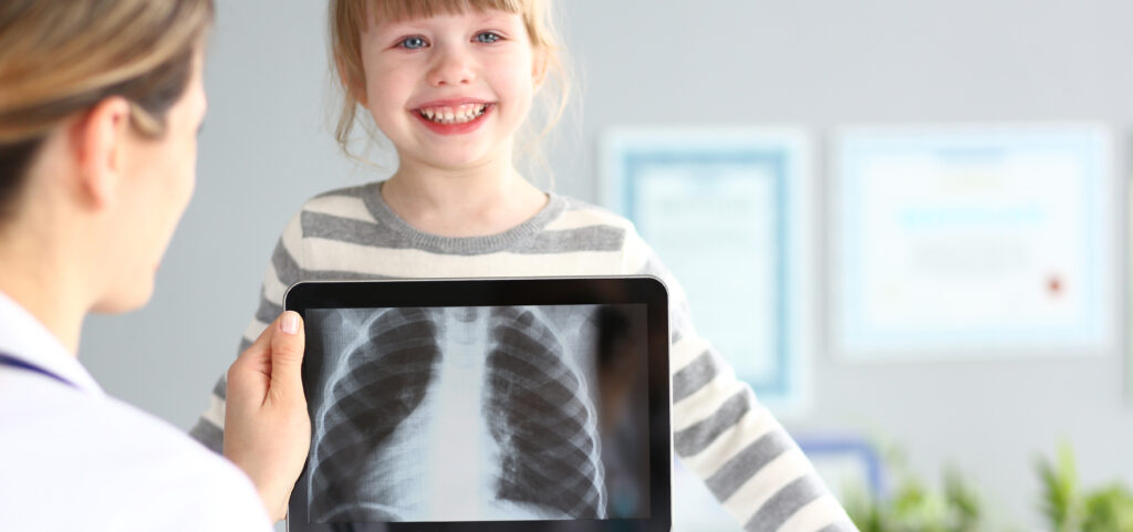 female doctor examining little girl with ultra modern scanning tablet pc device 1 LIV Hospital