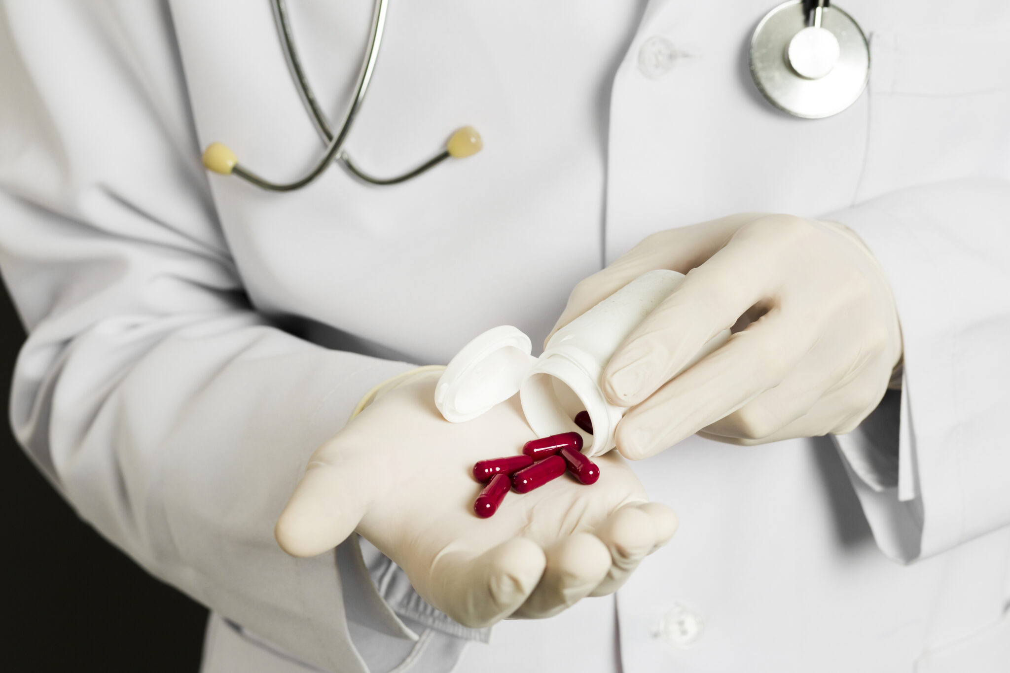 high angle doctor with surgical gloves holding pills 1 scaled LIV Hospital