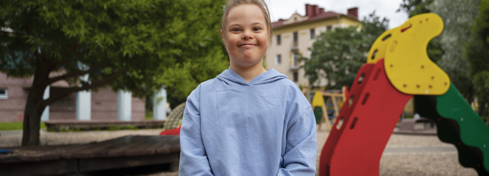 front view girl with down syndrome park 1 scaled LIV Hospital