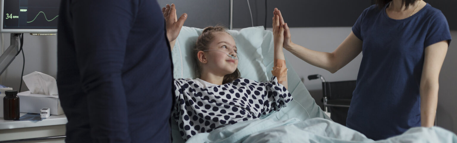 caring parents high fiving sick little daughter treatment resting children healthcare facility loving mother father doing high five gesture with ill girl sitting patient bed 1 1 LIV Hospital