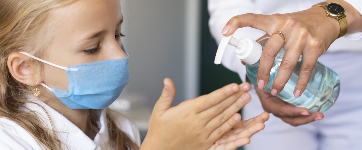 little girl disinfecting her hands 1 LIV Hospital