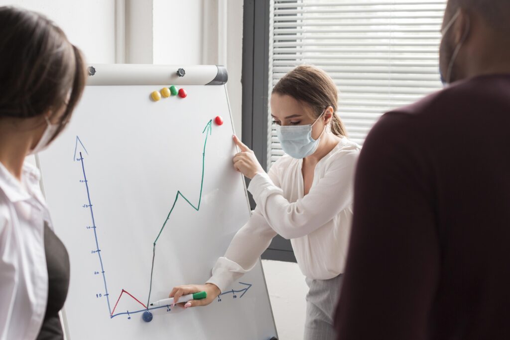 woman having presentation office pandemic with mask LIV Hospital