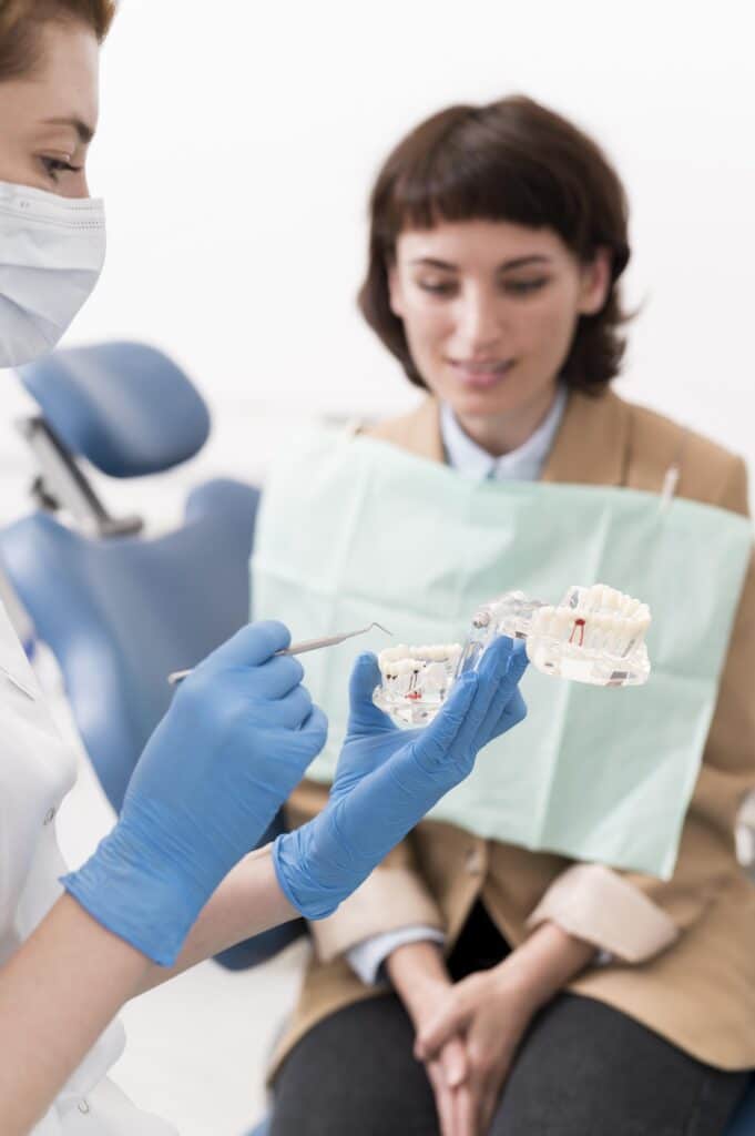 female patient looking dental mold with orthodontist LIV Hospital