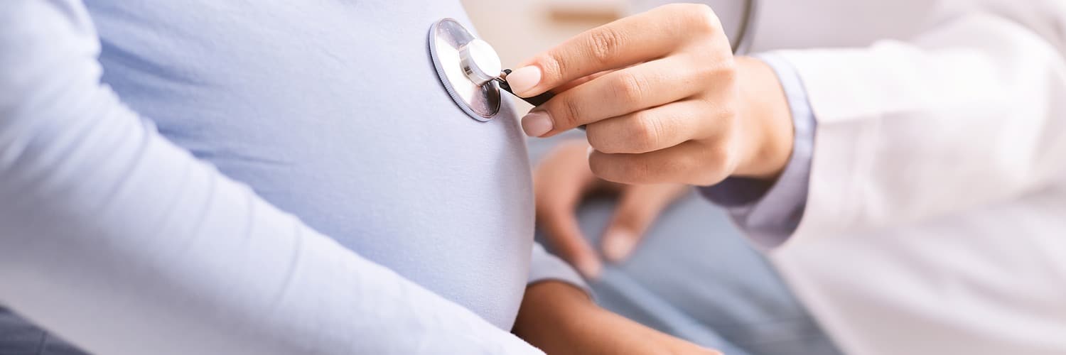 unrecognizable doctor holding stethoscope near pregnant womans belly indoor cropped x banner 1500 500 LIV Hospital