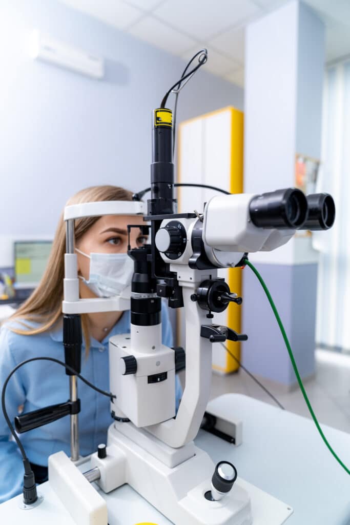 adult woman checks eyesight with binocular slitlamp checking retina female eye closeup modern ophthalmology clinic LIV Hospital