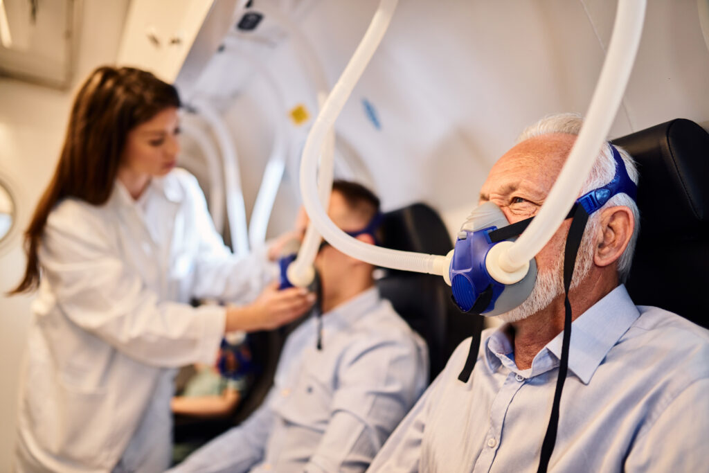 senior man breathing through mask oxygen therapy hyperbaric chamber LIV Hospital