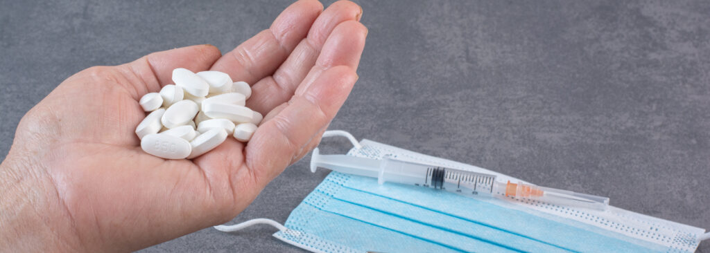 woman holding bunch pills medical tools table 1 LIV Hospital